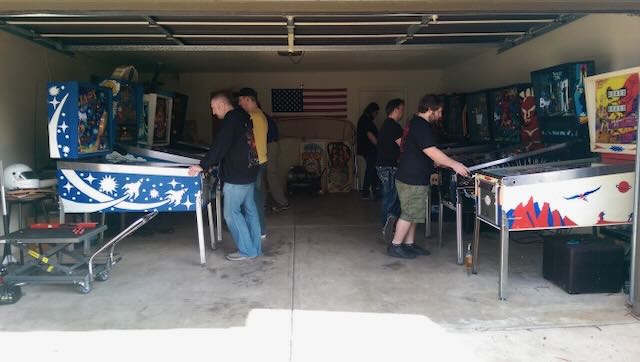 A garage set up for league night, machines lined along both walls