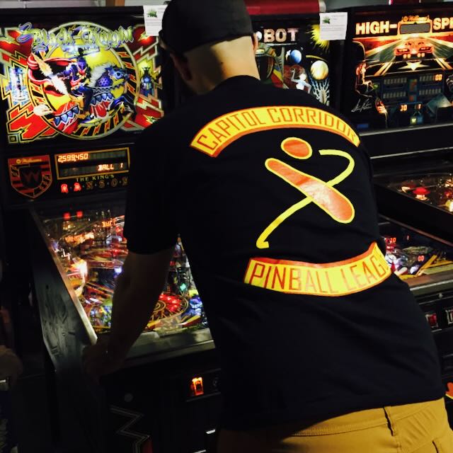 The back of a CCPL shirt, its logo facing a row of machines