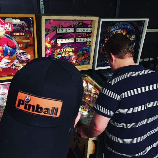 A player in a Pinball cap lining up a shot