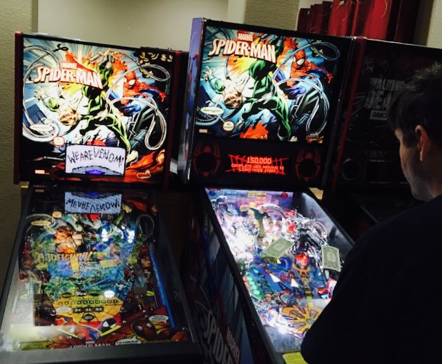 A Spider-Man machine, backglass lit and playfield ready